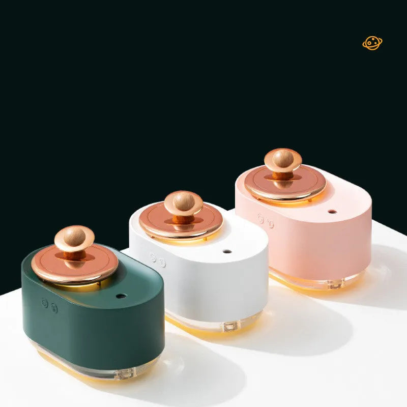 Green rotating planet humidifier with USB charging port and night light on wooden surface