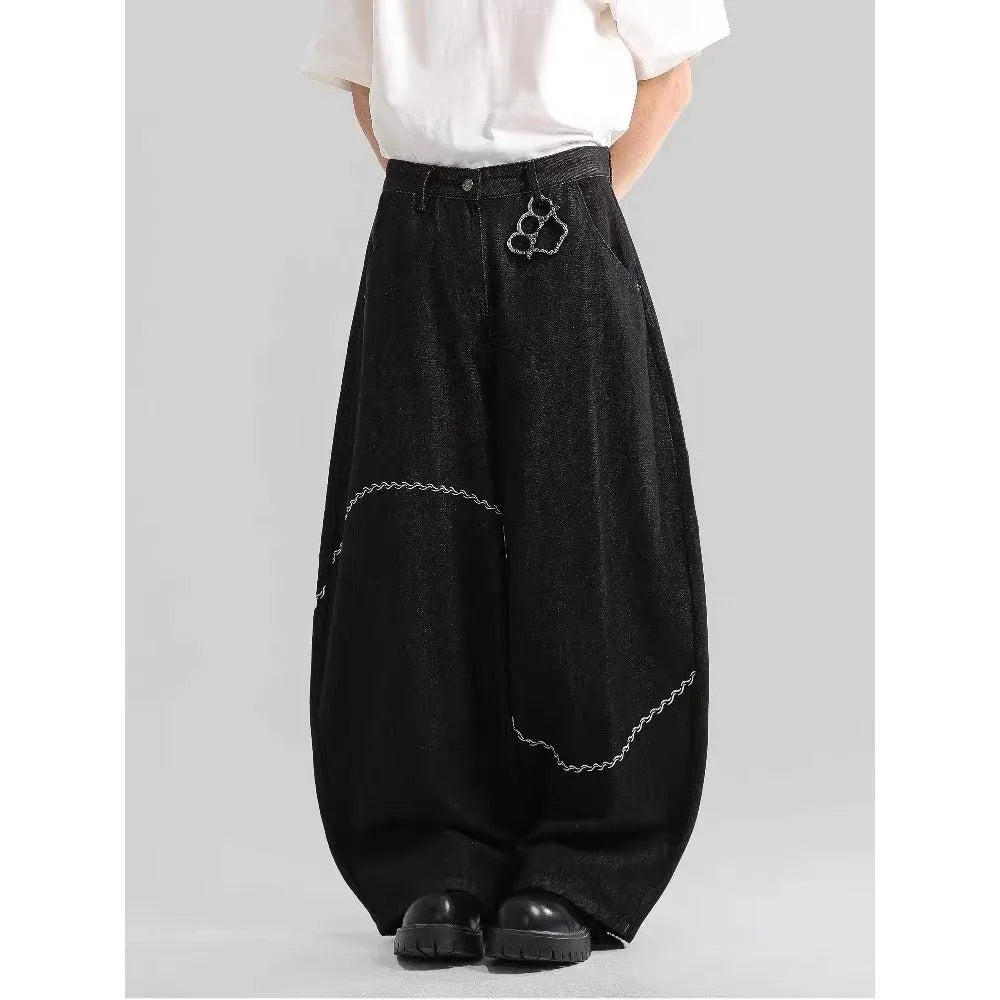 Black straight-leg denim trousers with micro-elastic fabric and mid-waist zip fly