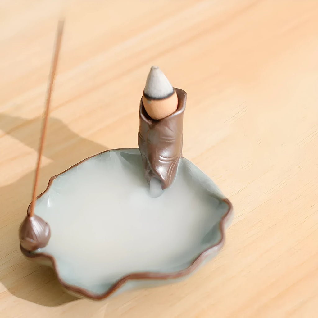 Ceramic reverse flow incense burner in purple clay with Ge kiln finish and lotus or plum blossom design