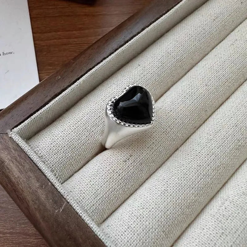 Adjustable open mouth sterling silver ring with a black heart-shaped agate stone.