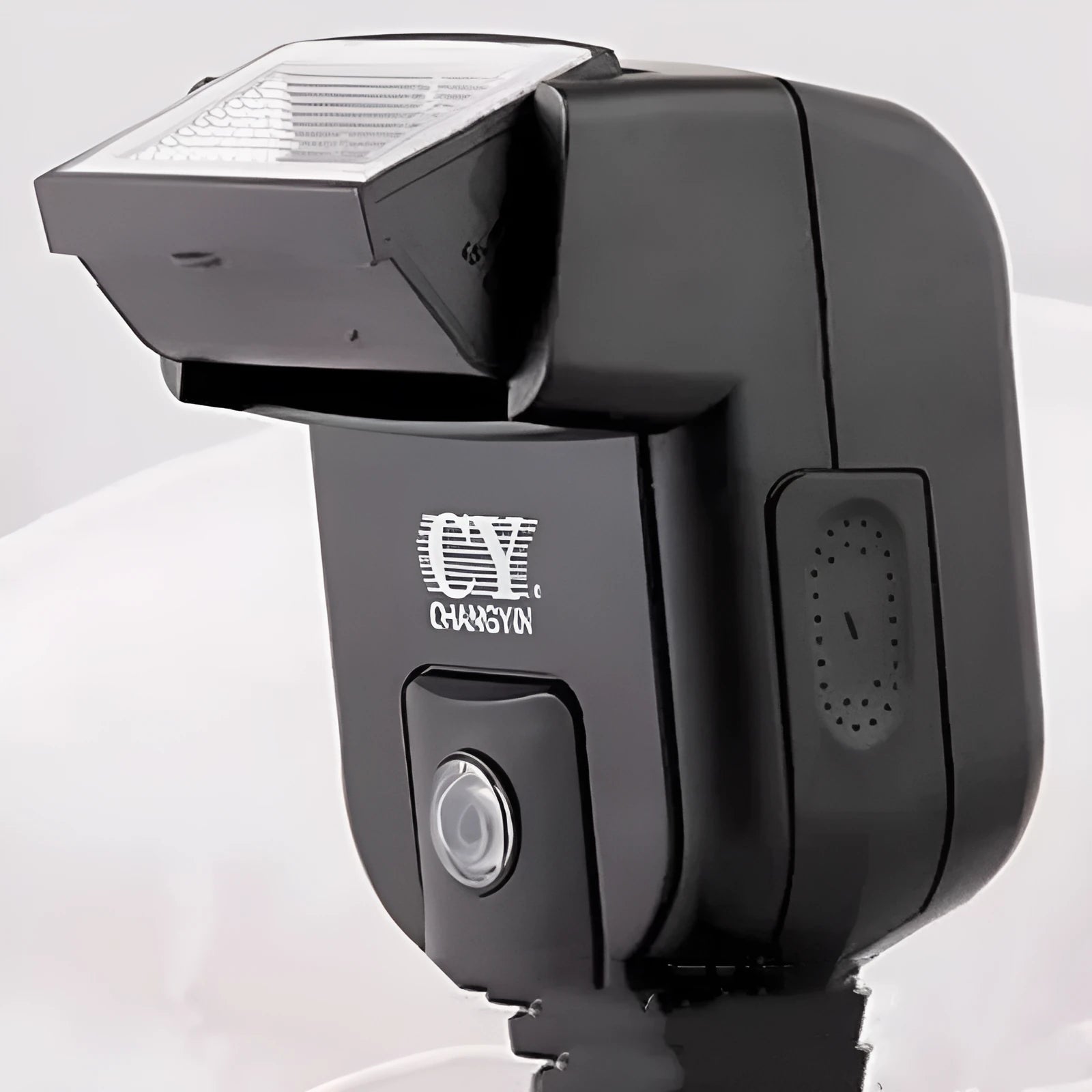 Compact SLR camera flash accessory unit shown tilted on a camera hot shoe, showcasing its 90-degree adjustable head.