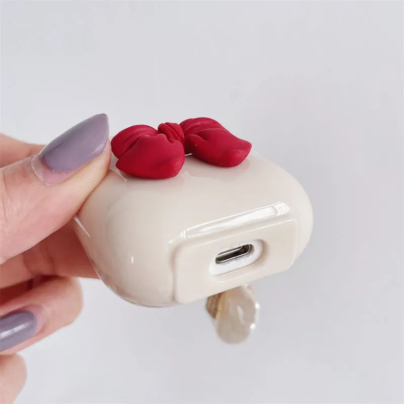 Beige red bow shell coloured TPU clamshell case cover for Apple AirPods charging case.