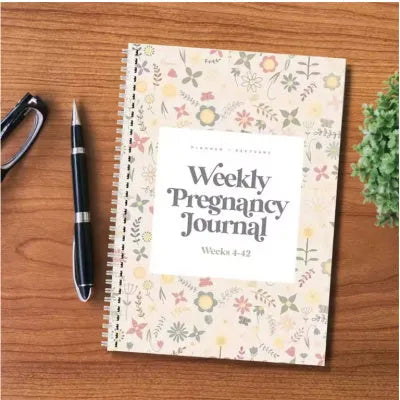 A5 pregnancy diary notebook open to weekly pregnancy tracking pages