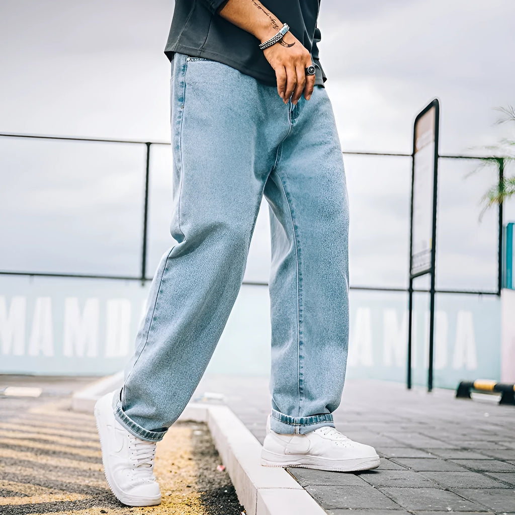 Men's loose straight simple jeans in dark blue cotton with mid waist and zipper fly available in plus sizes