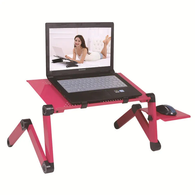 Red metal folding computer desk with cooling fans on a bed, holding a keyboard and mouse