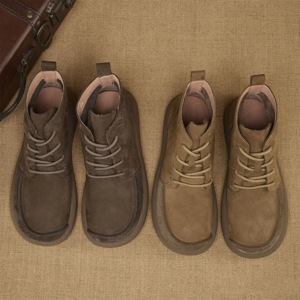 Grey genuine leather martin boots with wedge heel and lace-up front on a white background.