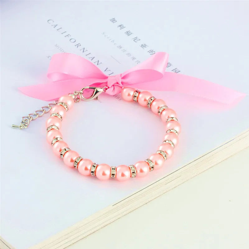 Adjustable dog necklace with imitation pearls, rhinestones, and ribbon bow for small pets