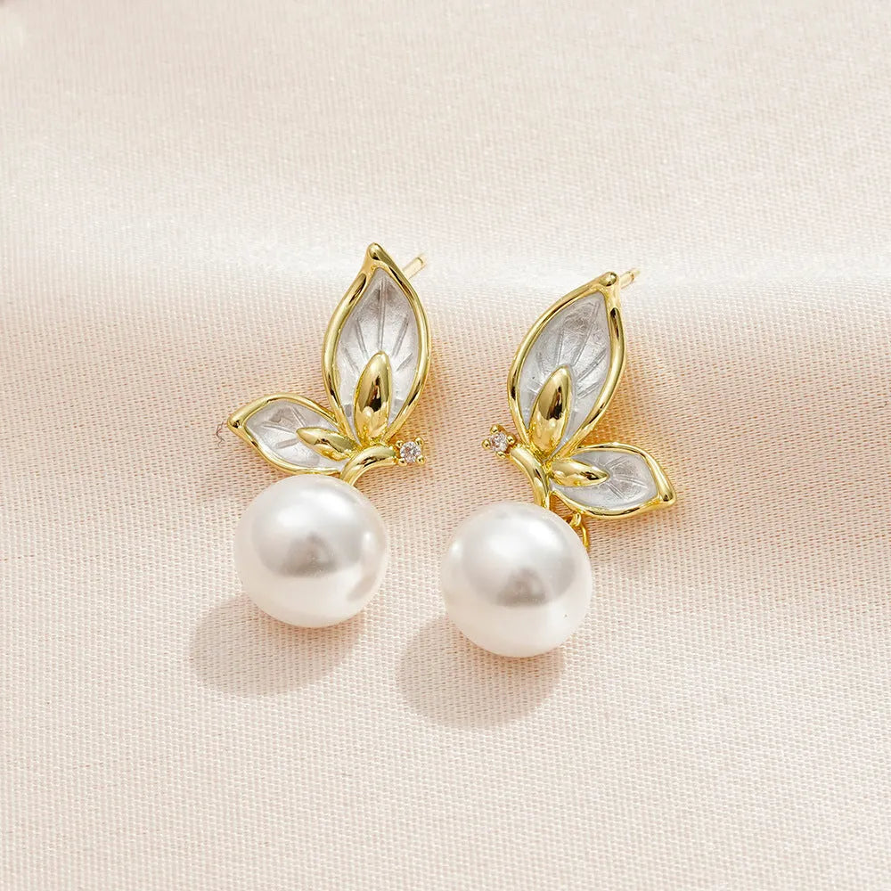 A pair of simple butterfly drop earrings for women with an electroplated finish on a copper base.