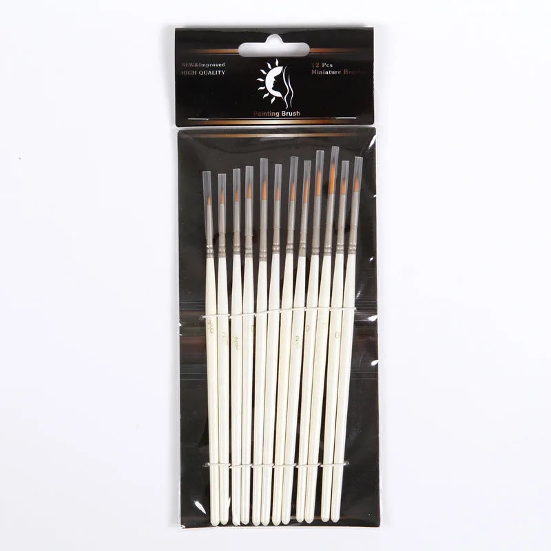 12 pearl white handled artist brushes with nylon wool bristles, stored upright in a solid wood pen holder.