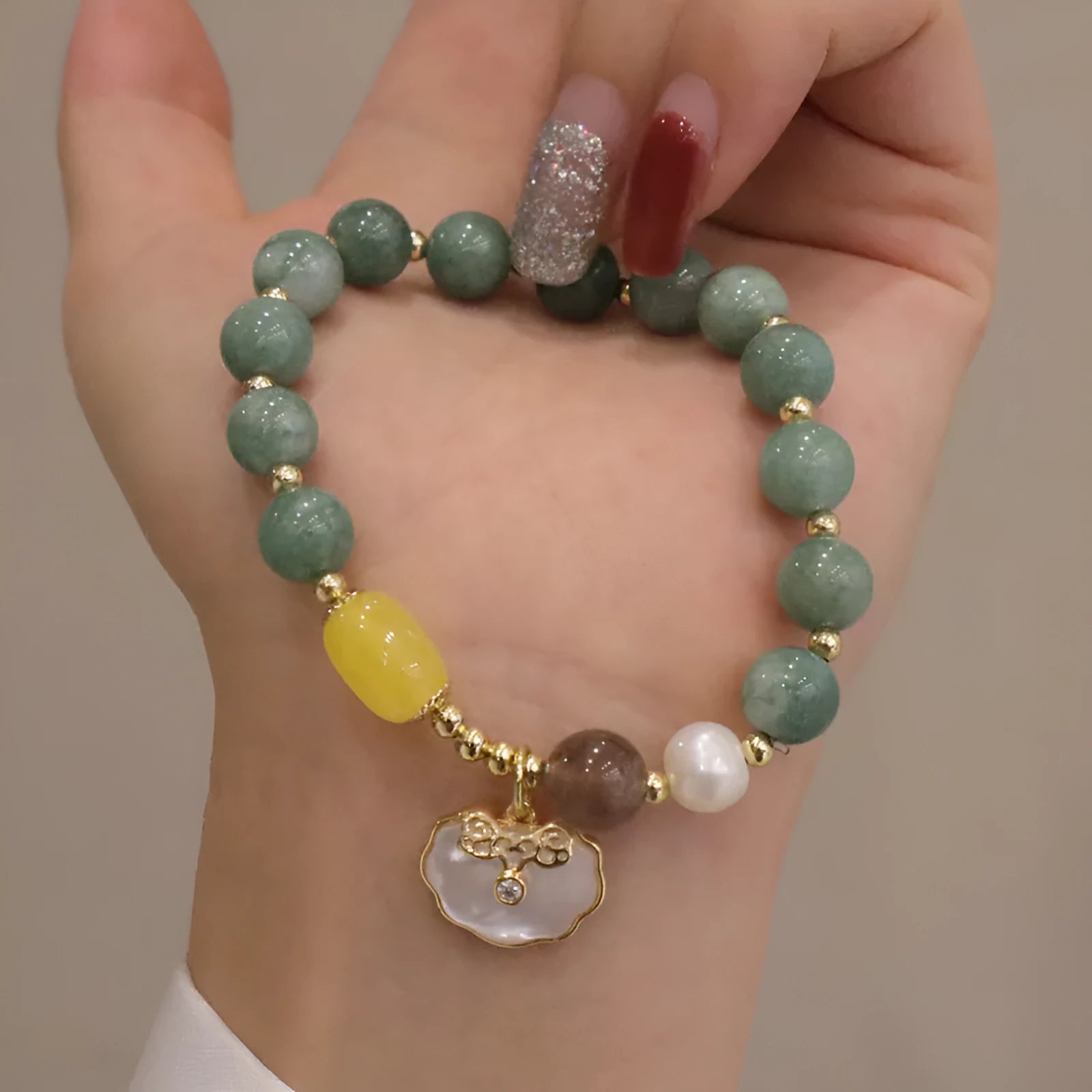 Green jade shell bracelet on a wrist showing natural stone beads and 18 cm length.