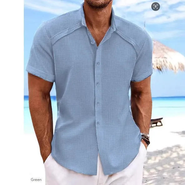 Man wearing a solid colour short sleeve Hawaiian casual shirt in a cotton blend fabric.