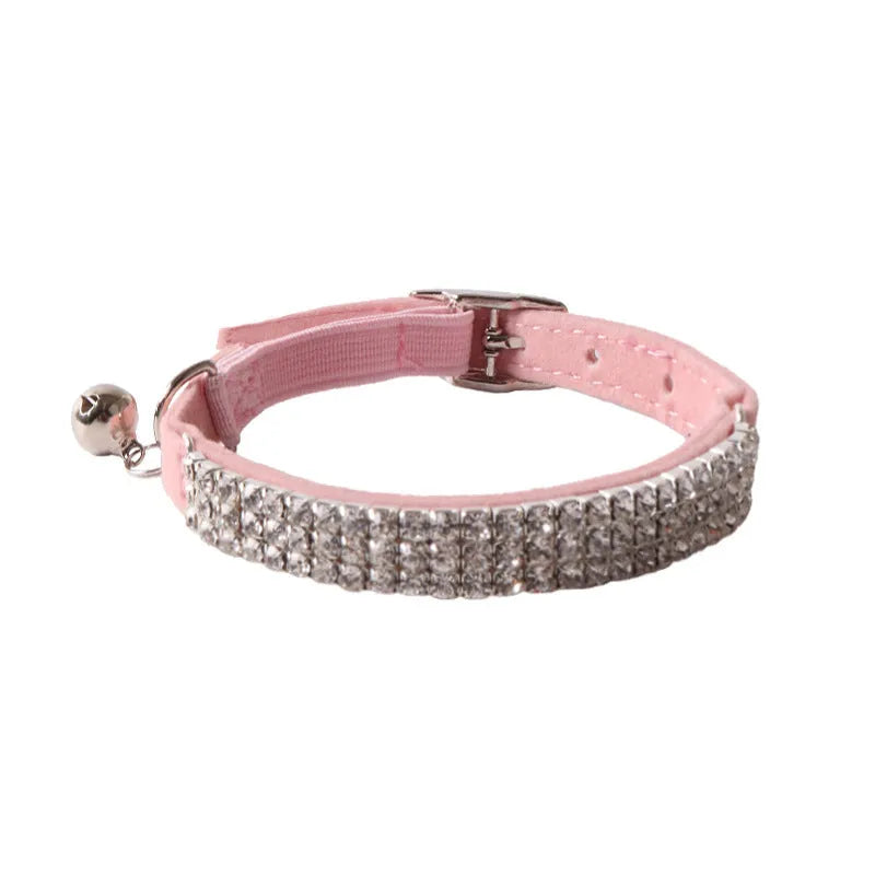 Flocked material cat collar with elastic buckle in assorted colours on a white background.