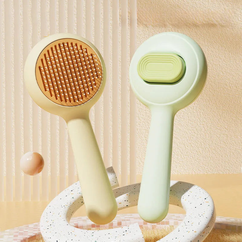 Green stainless steel cat grooming brush with non-slip handle for pet hair removal