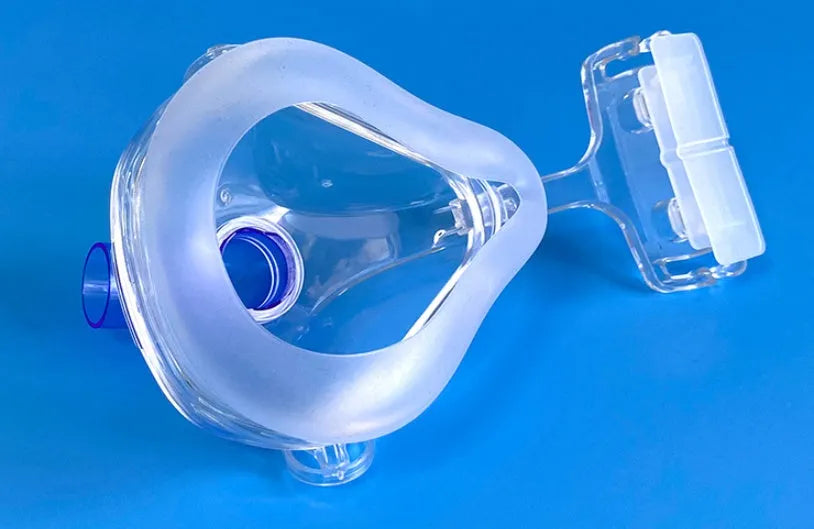 Transparent CPAP breathing mask with silicone and PC materials, headgear, and adapter elbows.