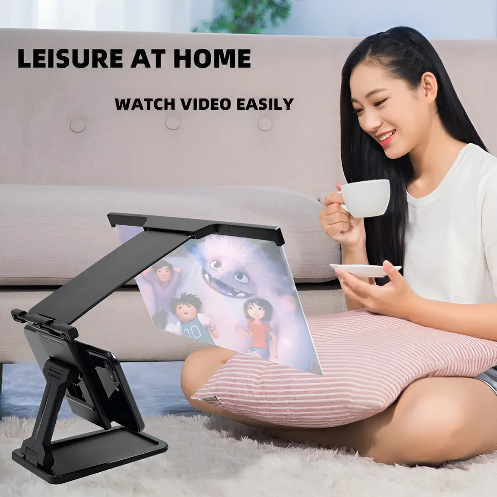 Black folding mobile phone screen amplifier with detachable phone holder on desktop