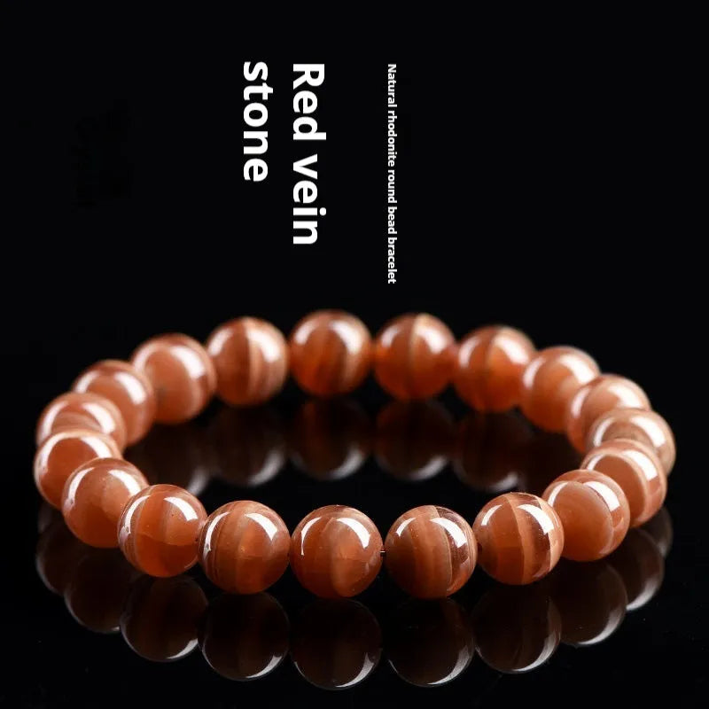 Natural Old Mine rhodochrosite mineral bracelet with round manganese spar beads in geometric design.