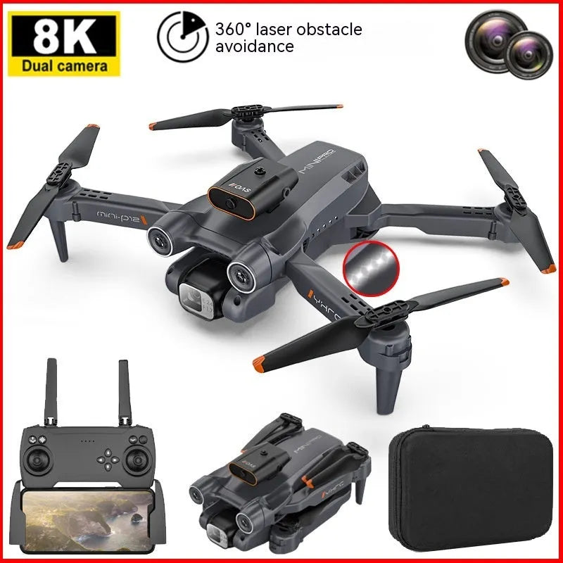 Black quadcopter drone with camera folded on a surface next to its remote control.