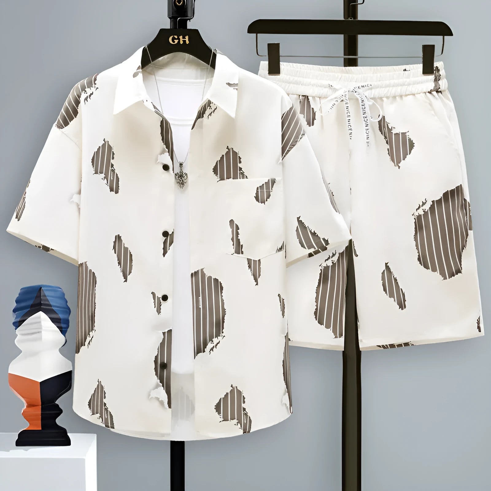 Men's grey casual polyester sports set with short sleeve top and shorts on a hanger.
