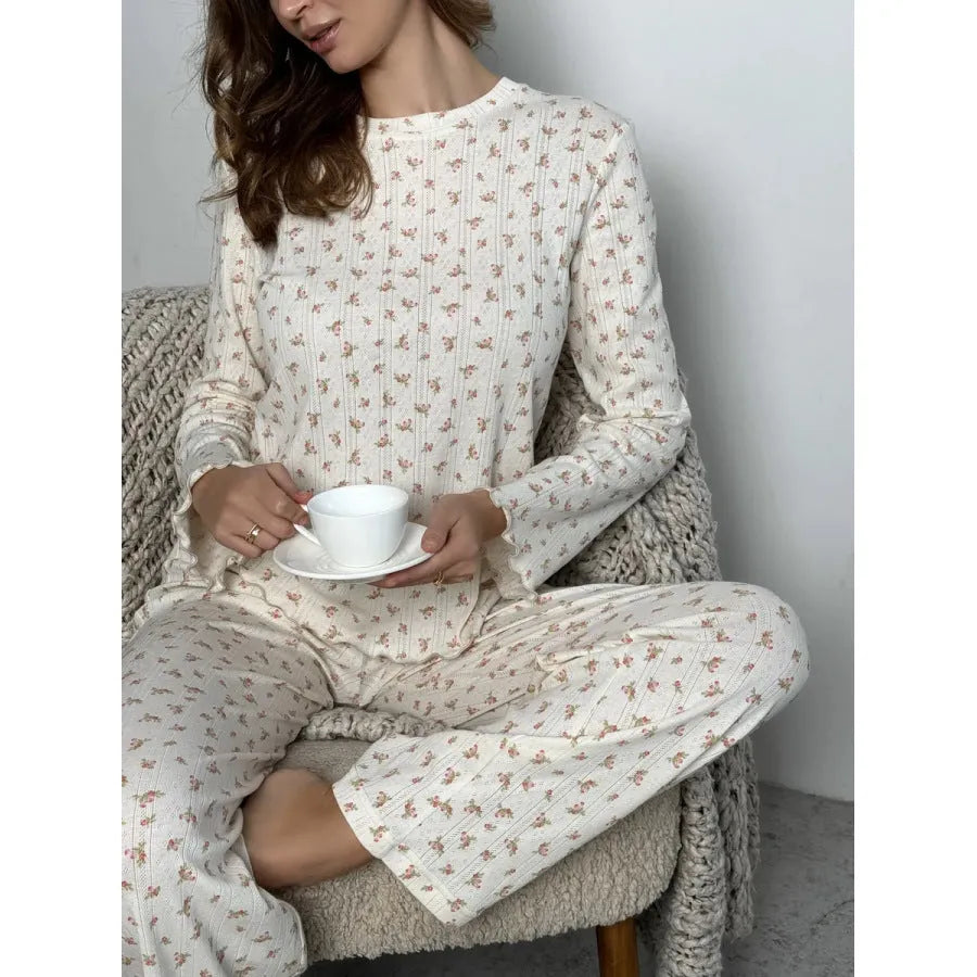 White floral print women's loungewear set with bell sleeve top and wide leg trousers.