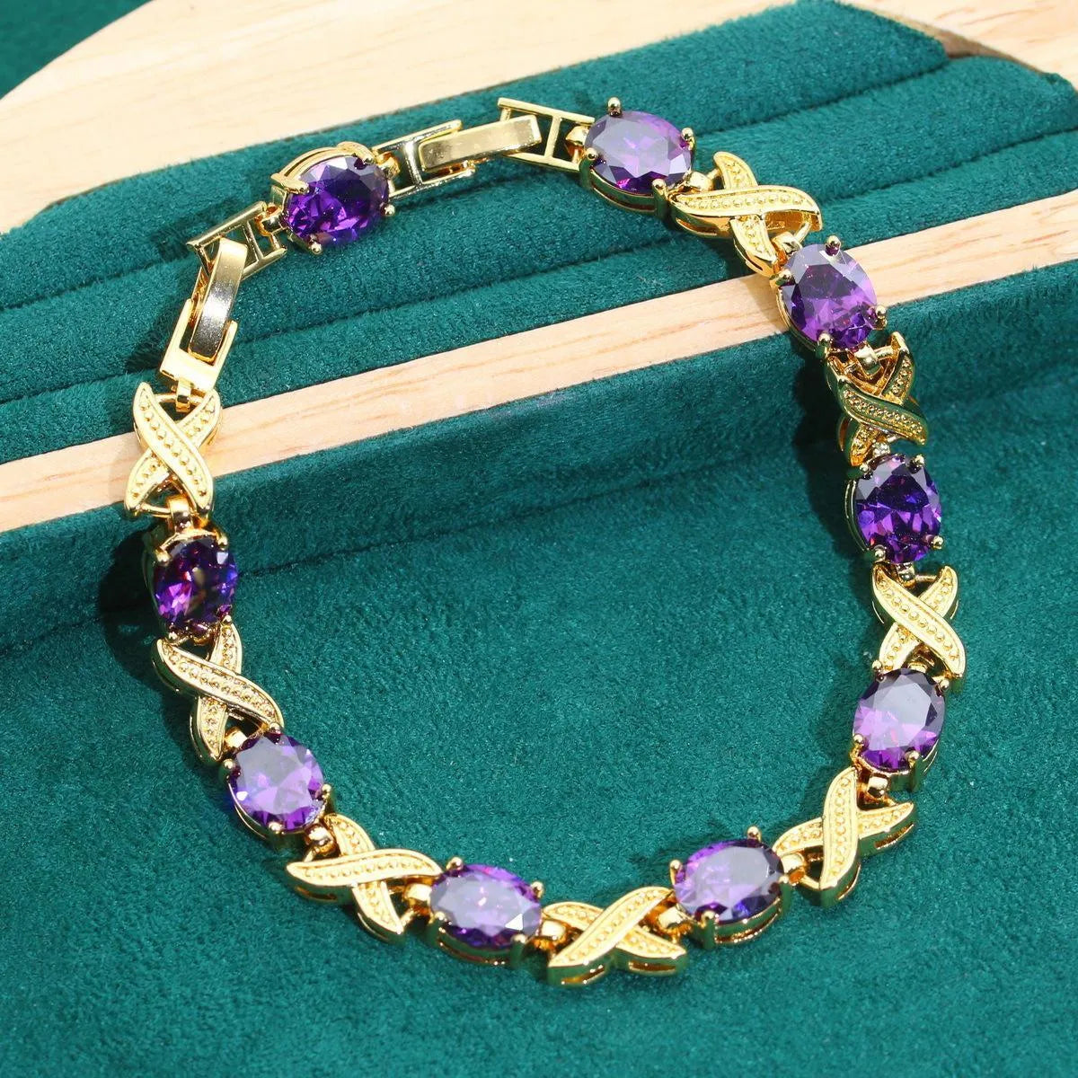 18k gold plated zircon jewellery set showing ring, earrings, bracelet and necklace in a coordinating colour.