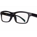 Black Bluetooth smart glasses with semi-open ear speakers and interchangeable lenses on a table with case.