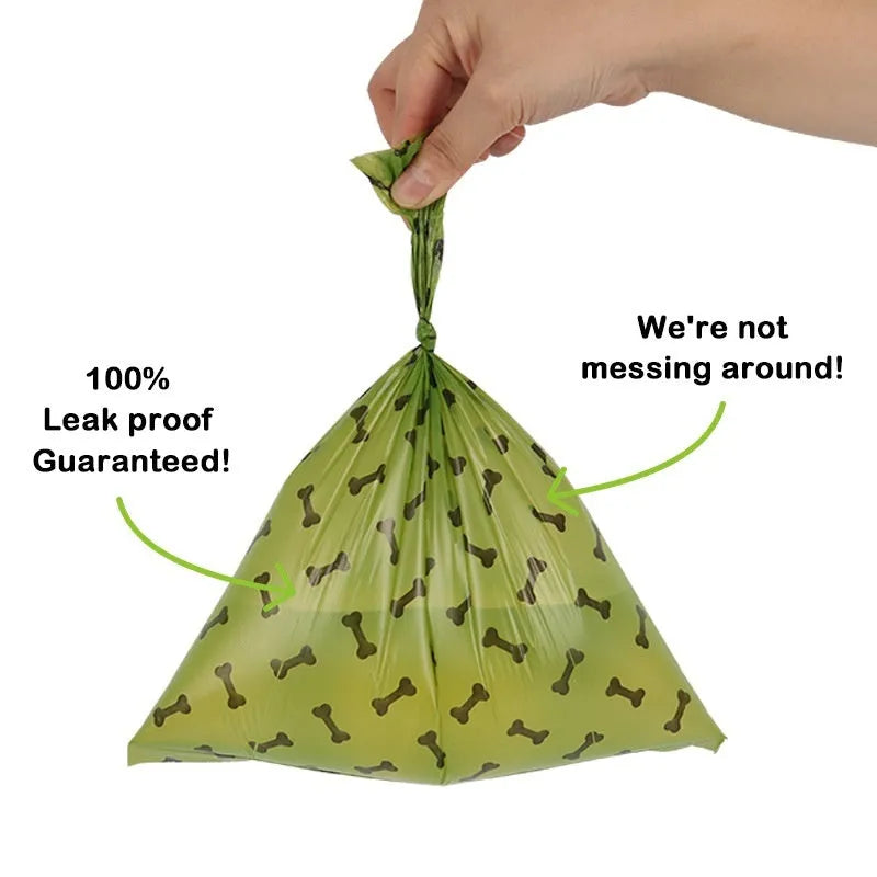 Roll of army green degradable dog waste bags with black bone print, 23cm by 33cm size.
