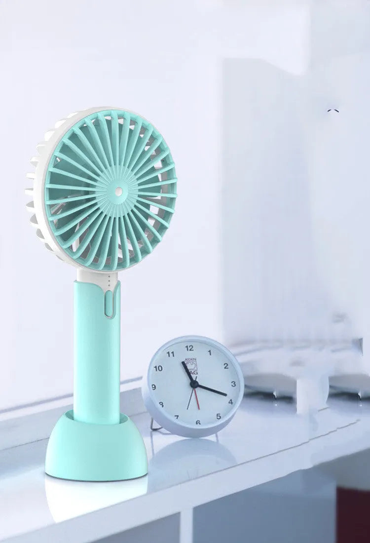 Blue handheld mini electric fan with USB cable, 3-speed buttons, and oscillating head