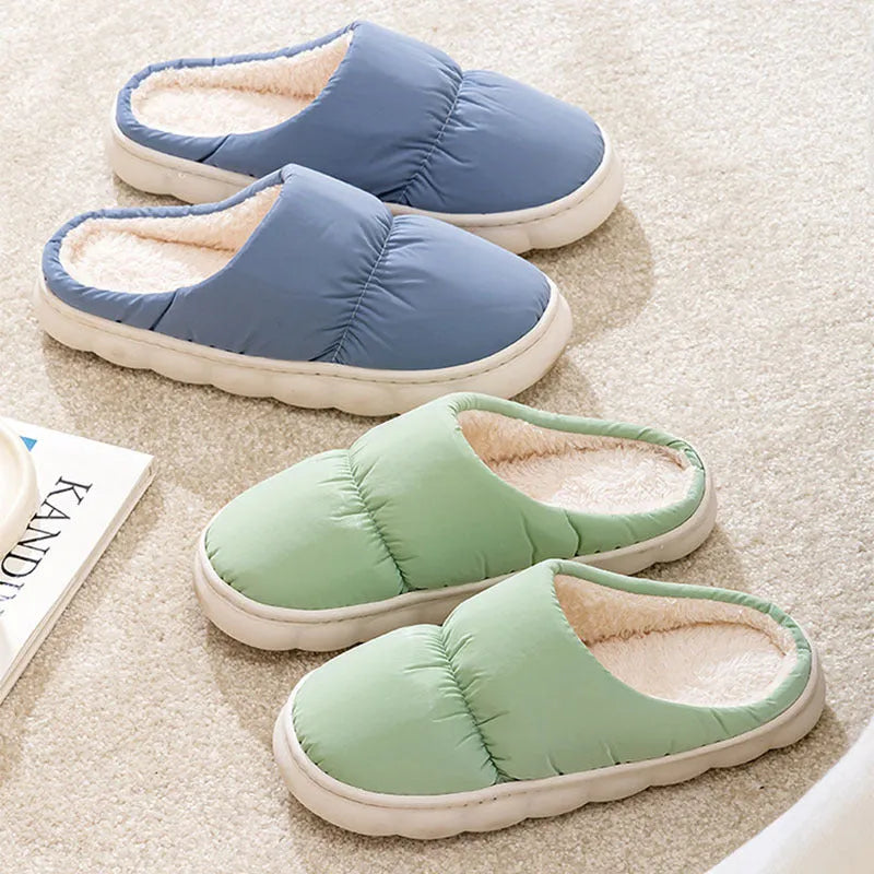 Pair of down cotton winter slippers with artificial leather upper, plush lining, and thick rubber sole.
