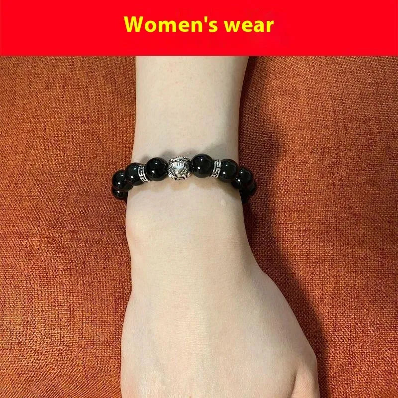 Natural obsidian and Silver 999 Cloud Year bracelet in simple unisex style on wrist.