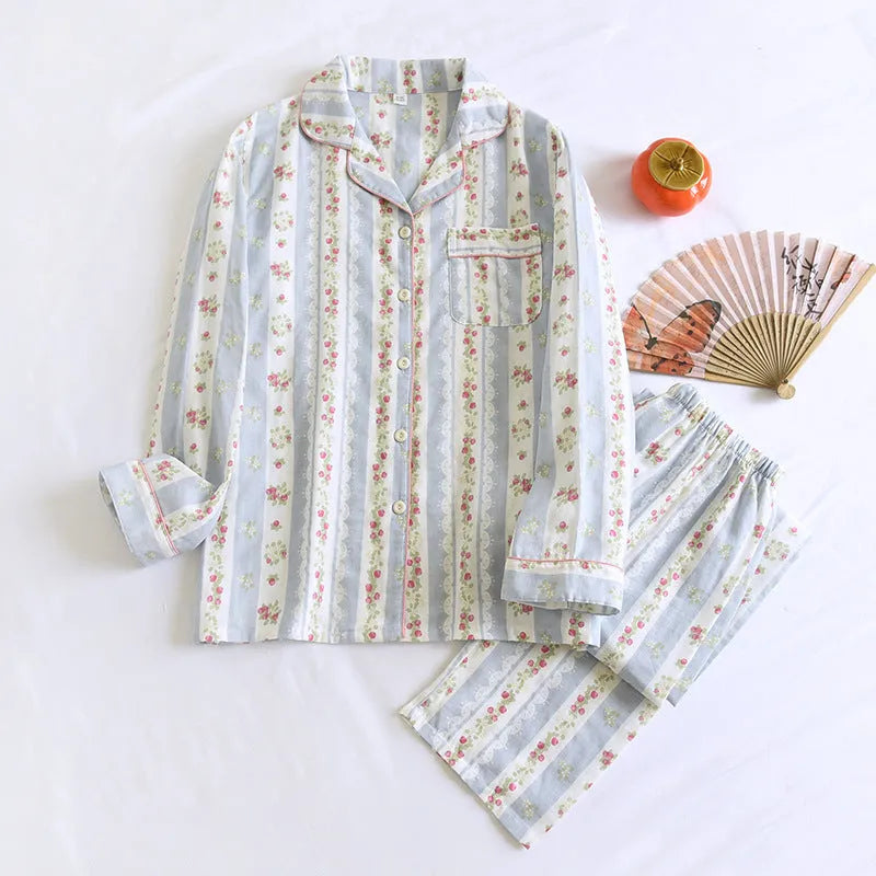 Woman wearing a red fruit print cotton gauze long-sleeved pyjama top and matching trousers.