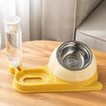 Elevated brown plastic cat food bowl with attached water bottle dispenser