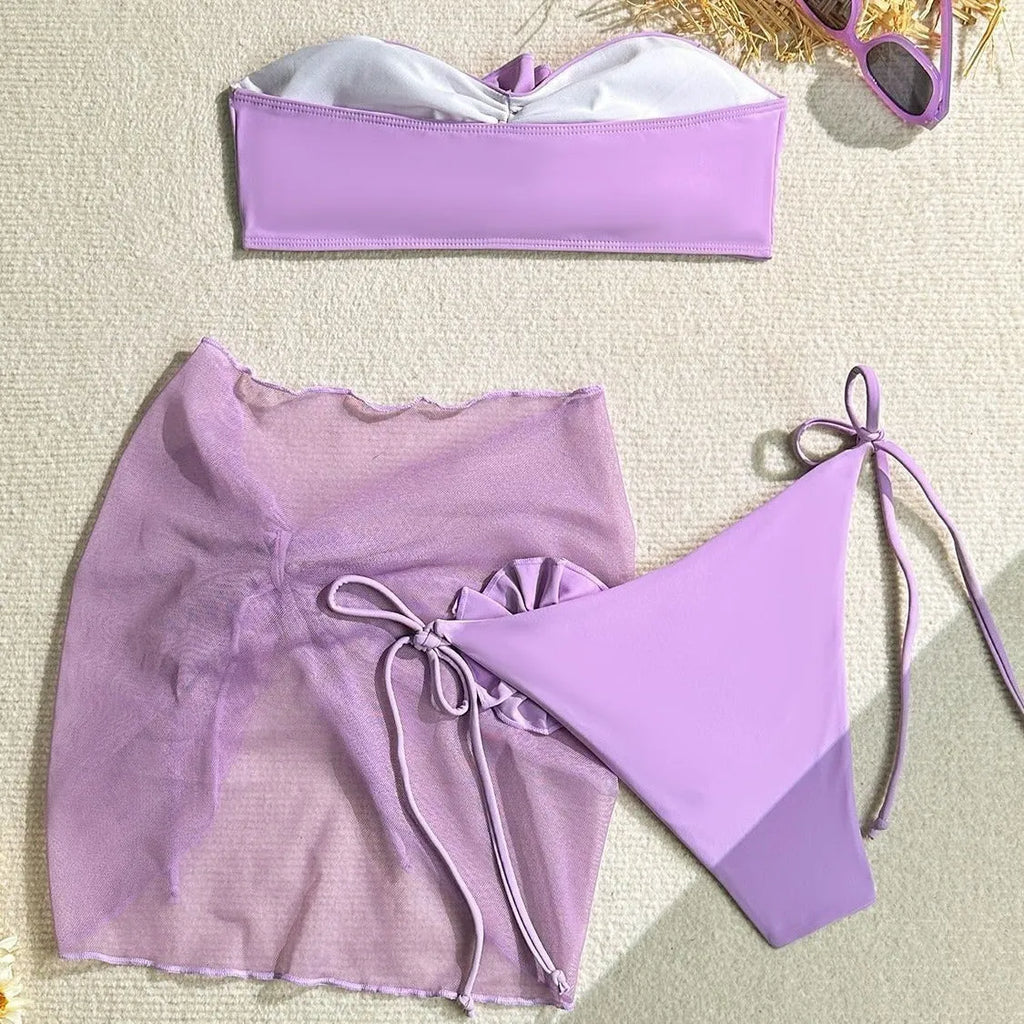 Women's pink tube top swimsuit with a large three-dimensional flower tie detail.