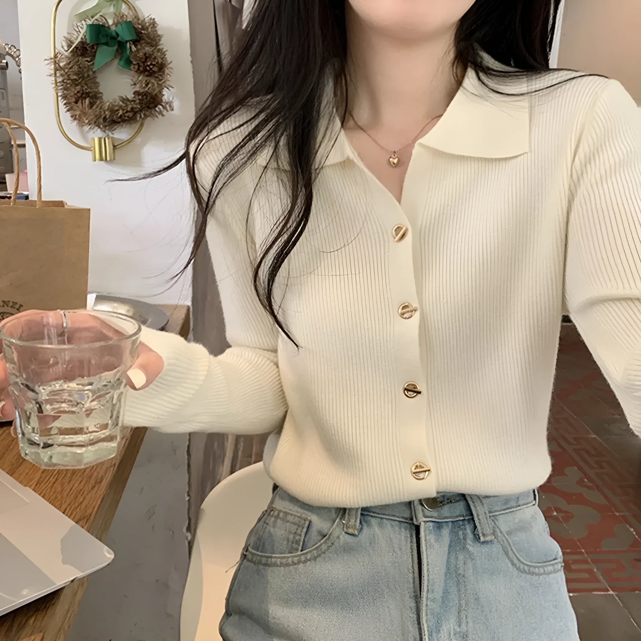 Beige loose fit long-sleeved viscose knitted cardigan for women shown as a layering piece.