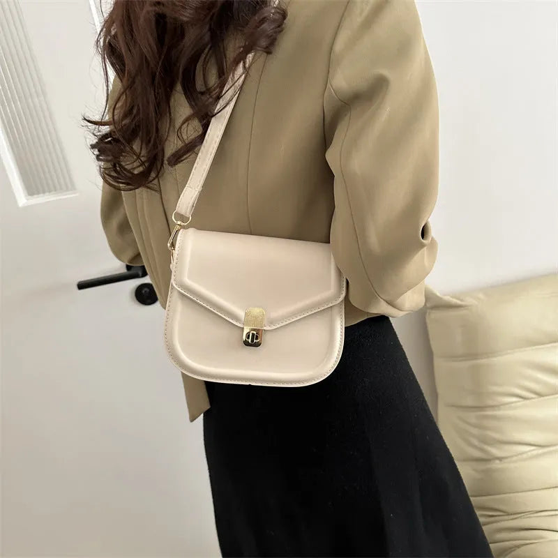 Soft PU leather messenger bag with clamshell opening shown in horizontal square shape on a shoulder strap.