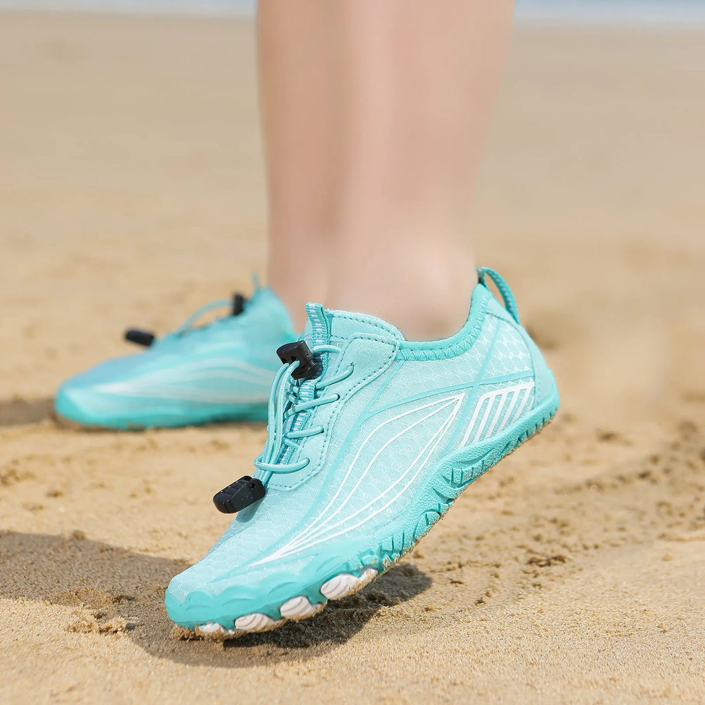 Children's quick-dry wading shoes in blue with rubber sole and elastic band, shown on a child's foot.