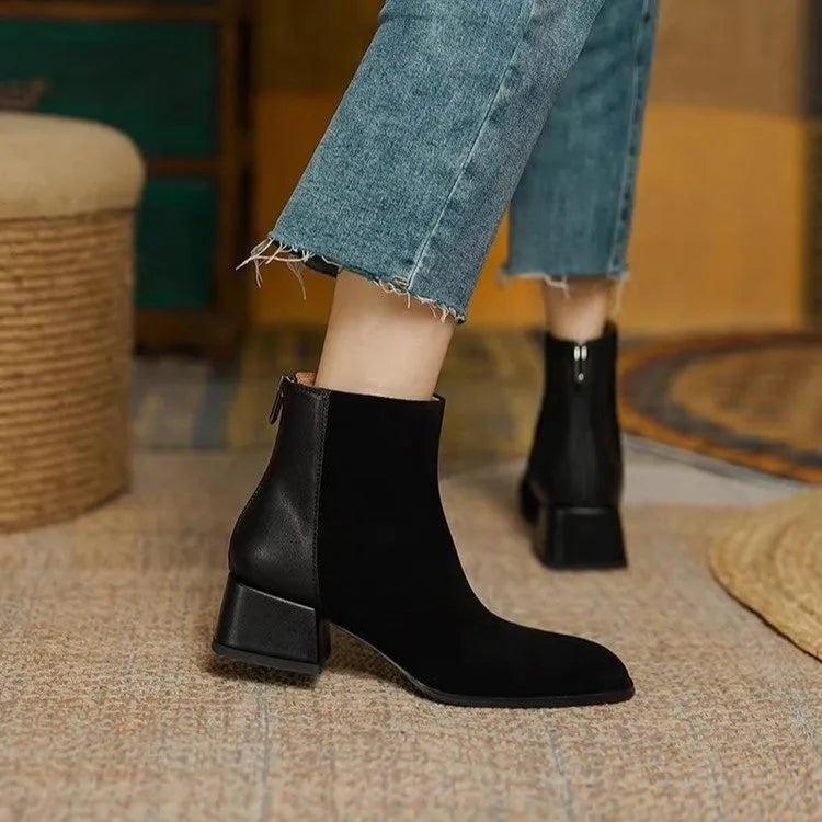 Women's suede martin boots in black with block heel and back zipper on a white background
