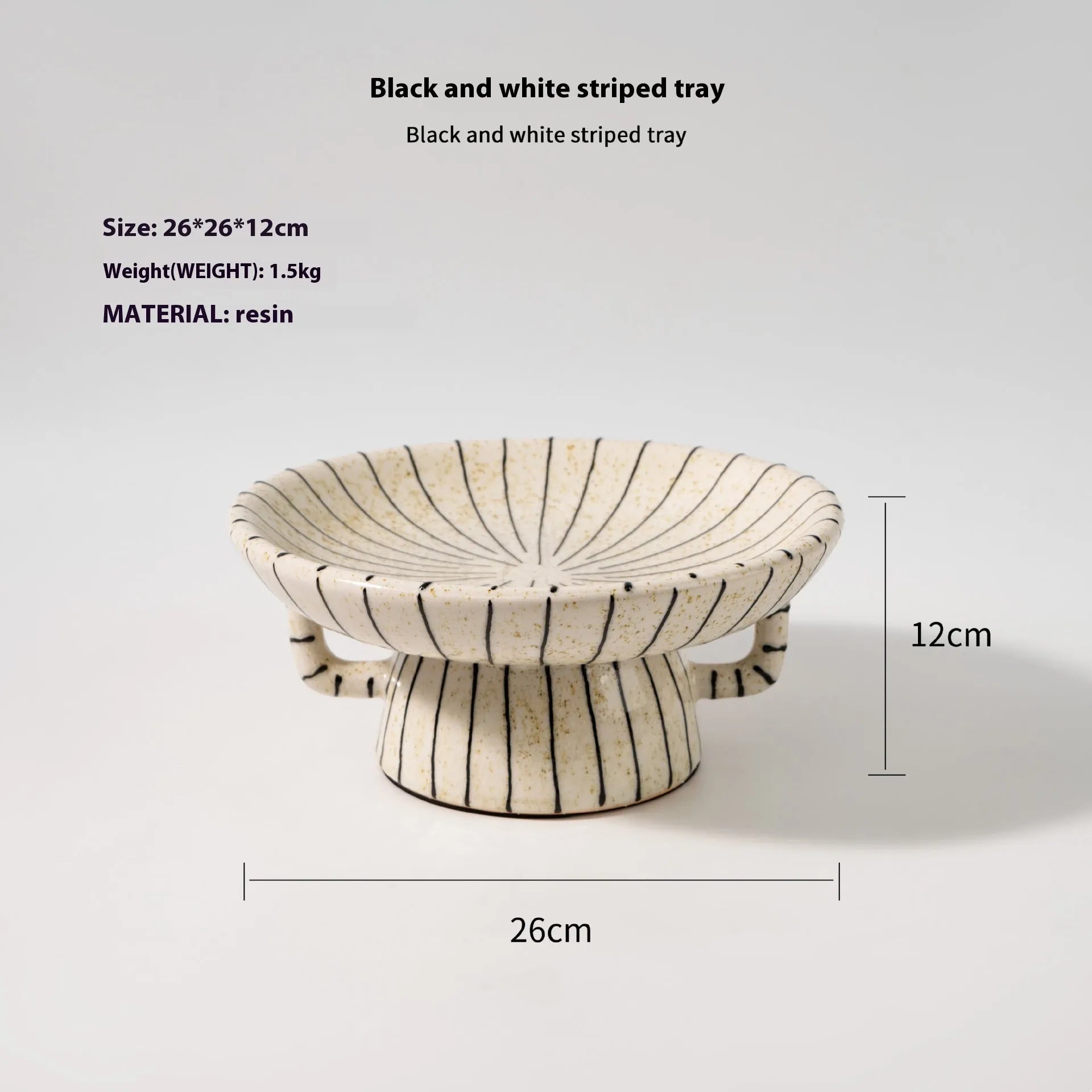 Black and white striped plastic resin dessert plate on a table.