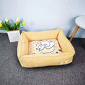Light blue cotton winter dog nest bed with soft padded interior, shown empty on a wooden floor.