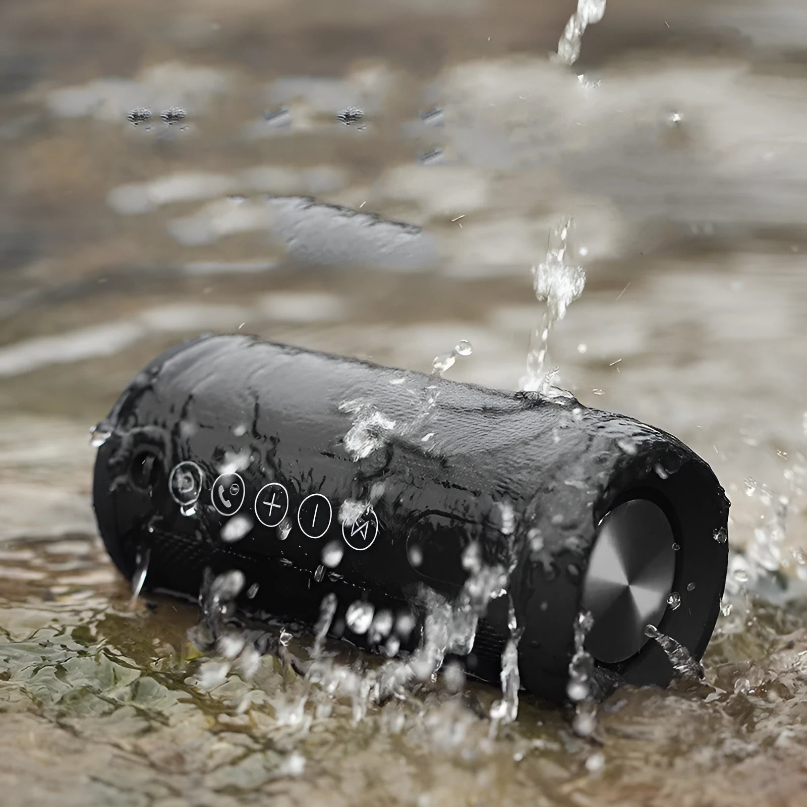 Black outdoor waterproof portable Bluetooth speaker on a grassy surface