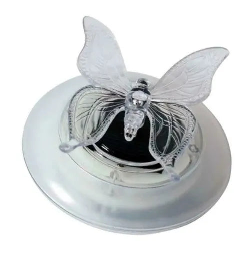 Solar LED float lamp with dragonfly ornament floating on pond water showing 7 colour changing lights