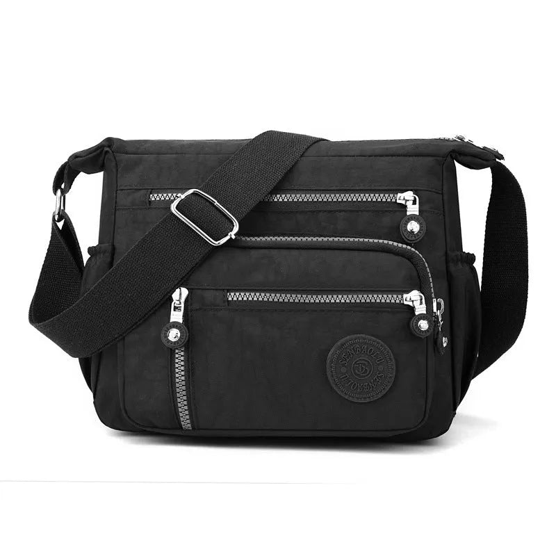 Soft nylon messenger bag in square vertical shape with an adjustable shoulder strap.