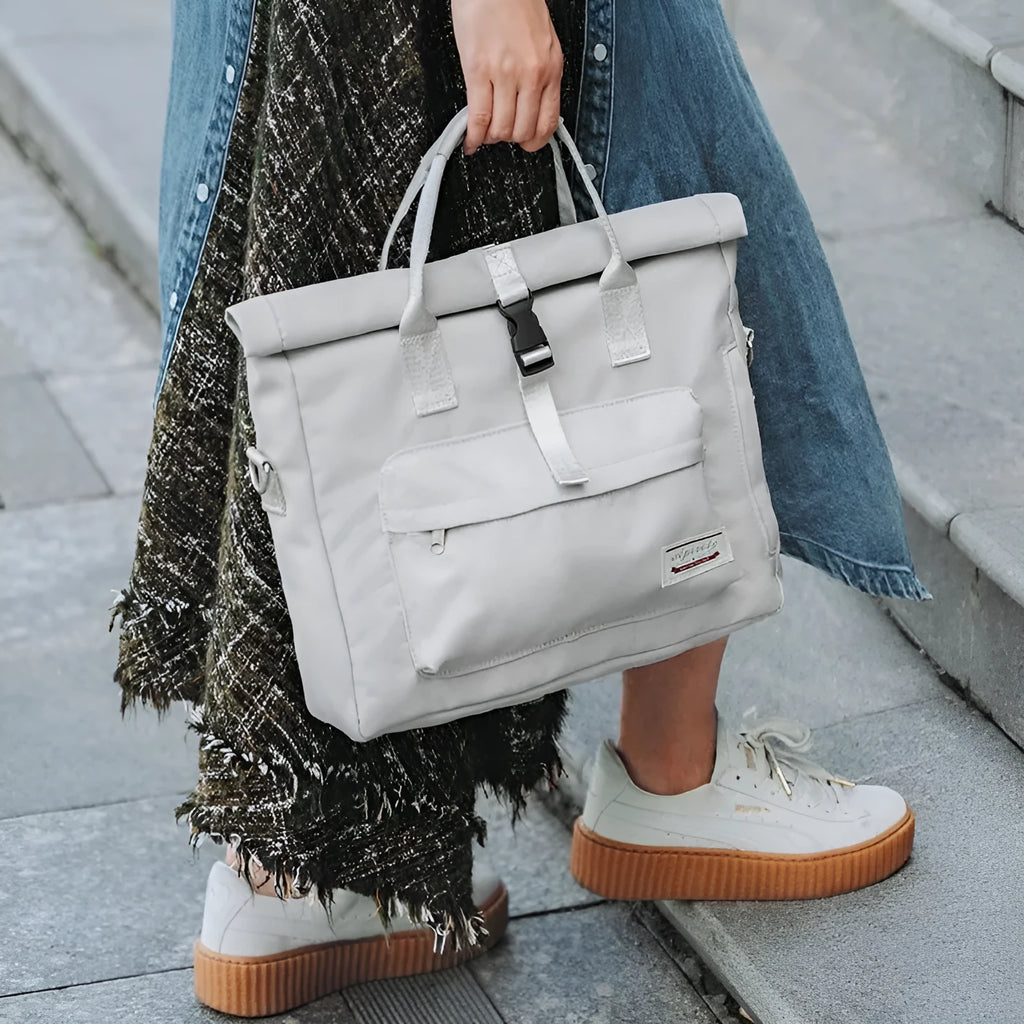 Shockproof inner liner laptop bag in waterproof nylon, shown in black, beige grey, or pink.