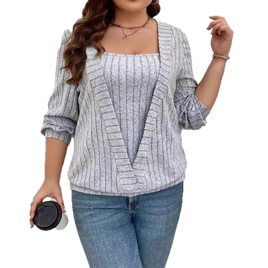 Solid colour rib fabric V-neck false two-piece suit with long sleeves on a hanger.