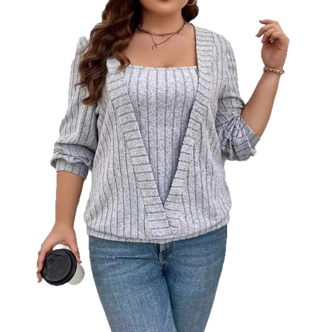 Solid colour rib fabric V-neck false two-piece suit with long sleeves on a hanger.