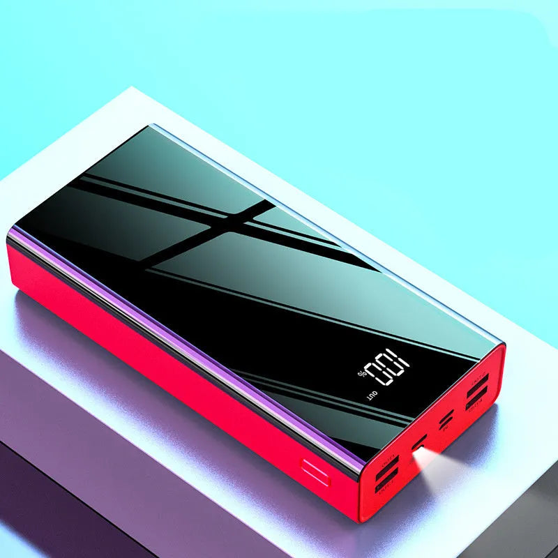 Large black and red 40000mAh power bank showing LCD screen displaying battery percentage.