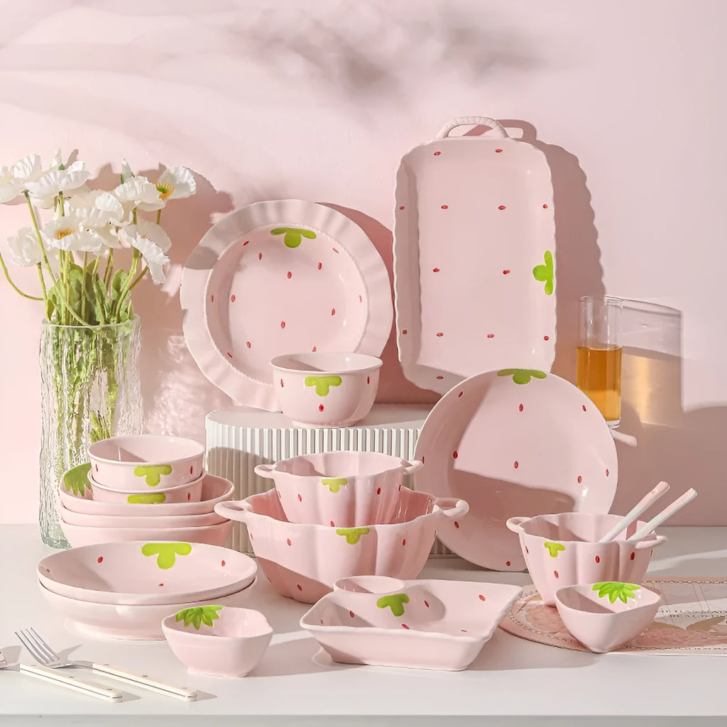 Porcelain dinnerware set with strawberry design: bowl, plate, and twist-handle spoon.