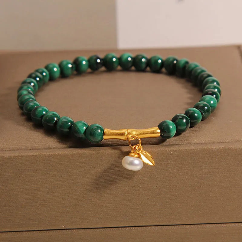 Women's white crystal bracelet with a raised lucky bamboo design centrepiece.