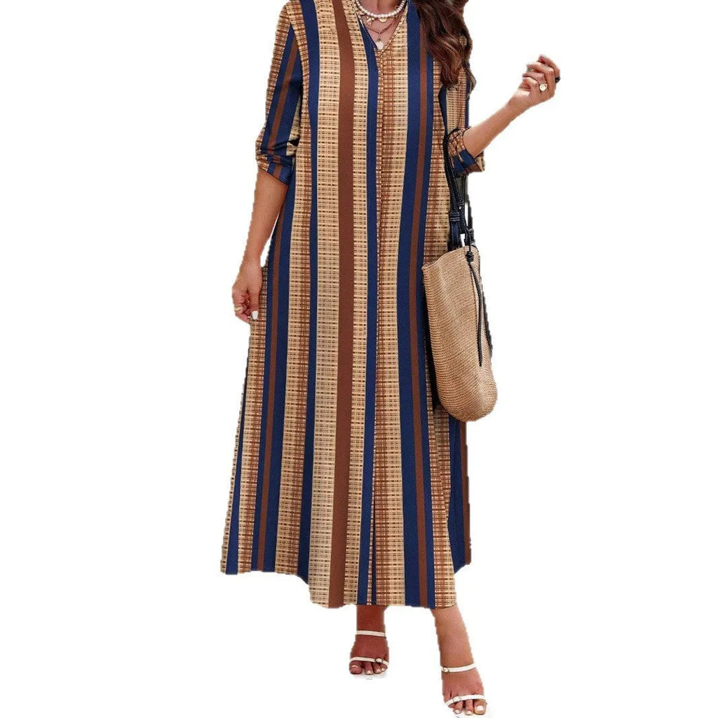 Camel coloured striped V-neck long sleeve knit dress with an A-line skirt on a hanger.