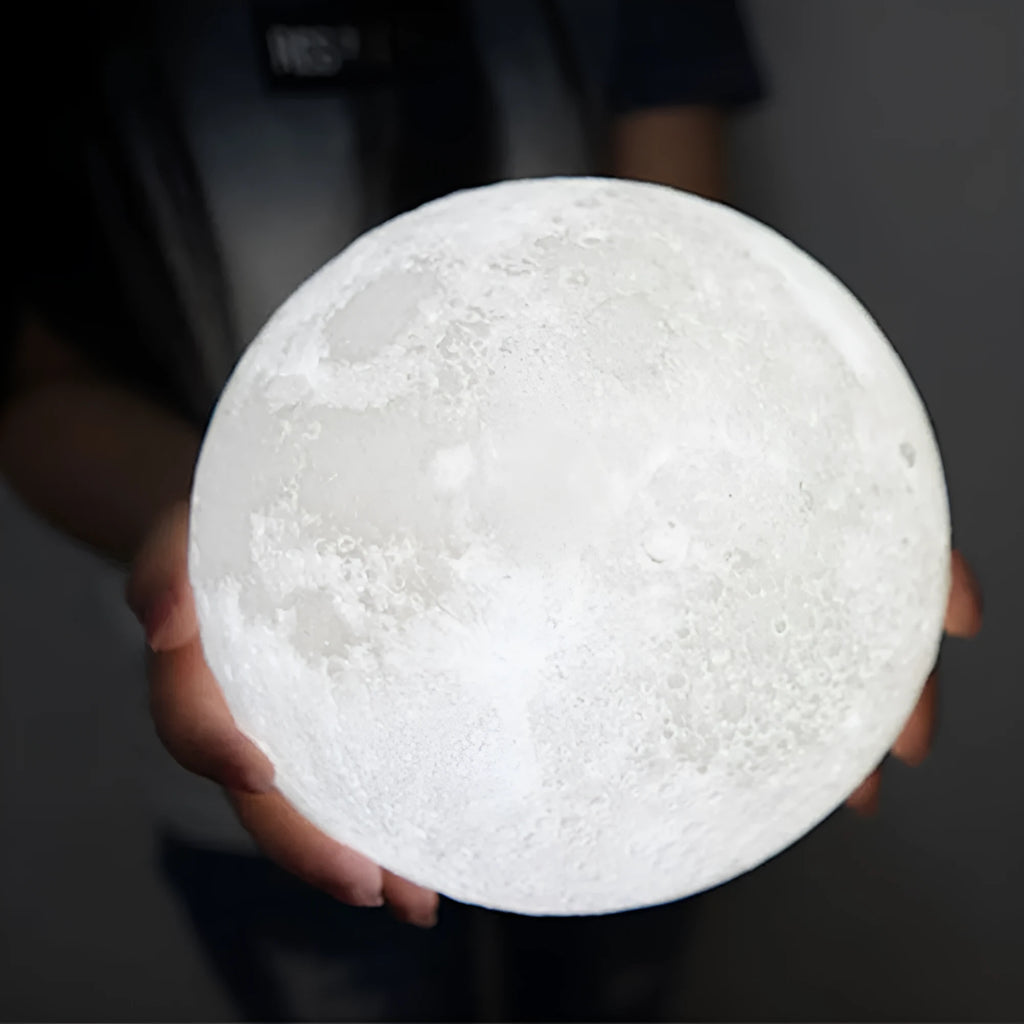 3D printed moon lamp on wooden stand with touch control ring at base, showing white and yellow light colours.