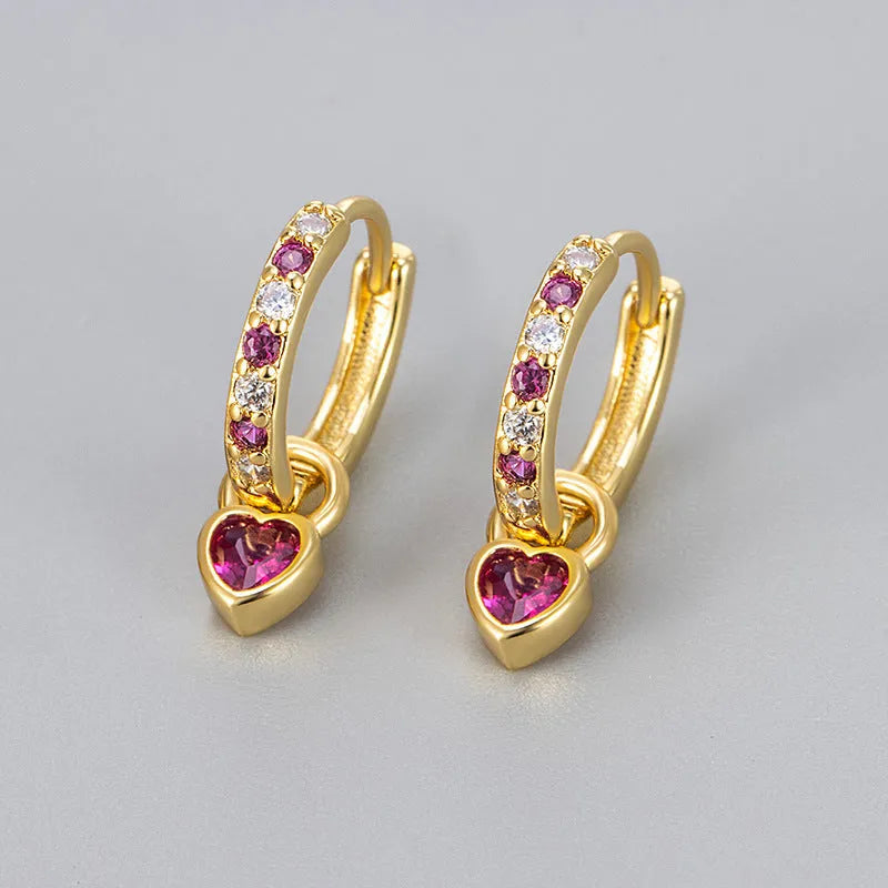 Heart-shaped ladies fashion earrings with coloured stone centrepiece and gold colour plating